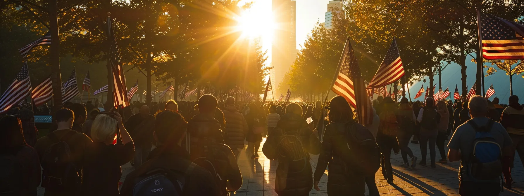a group of people holding american flags paying tribute at a memorial on september 11 patriots' day.